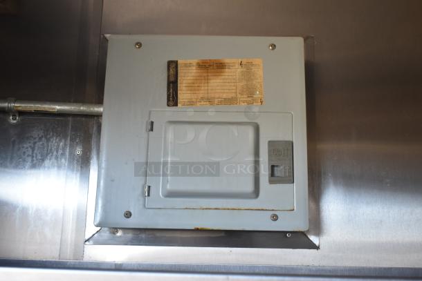 Electrical panel inside 2019 Quality Cargo 8.5' x 24' mobile kitchen trailer, featuring a visible GE breaker switch and label.