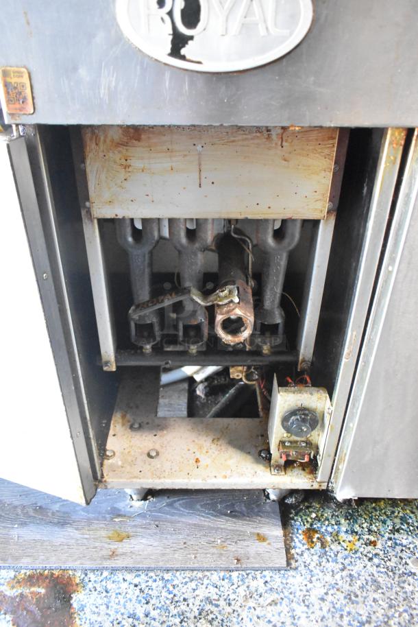 Interior of a mobile kitchen trailer with visible Royal brand cooking equipment, showing wear and grease buildup.