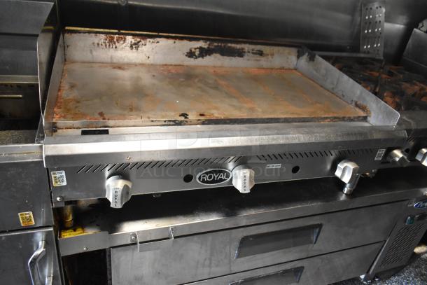 Royal griddle in a 2019 Quality Cargo mobile kitchen trailer. Features include grease hood and industrial controls.