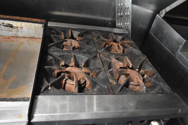 Stovetop burners and griddle inside a 2019 Quality Cargo 8.5' x 24' mobile kitchen trailer, part of the Burger King corporate spec kitchen equipment.