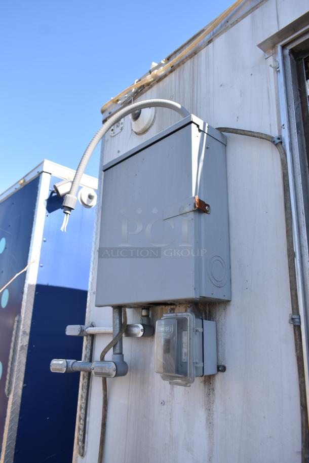 2019 Quality Cargo 8.5' x 24' mobile kitchen trailer exterior with electrical hookups, metal casing, and visible wiring.