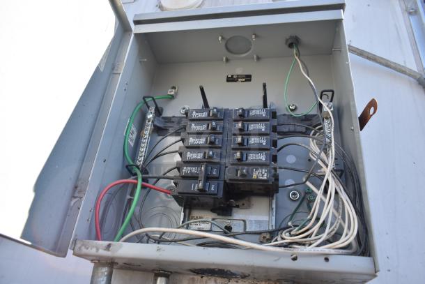 Electrical panel inside the 2019 Quality Cargo 8.5' x 24' mobile kitchen trailer, showing wiring and circuit breakers.