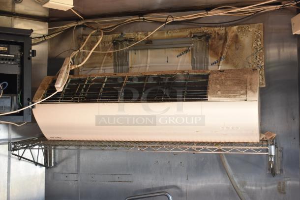 Interior of 2019 Quality Cargo mobile kitchen trailer showing a wall-mounted ventilation unit with visible wear.