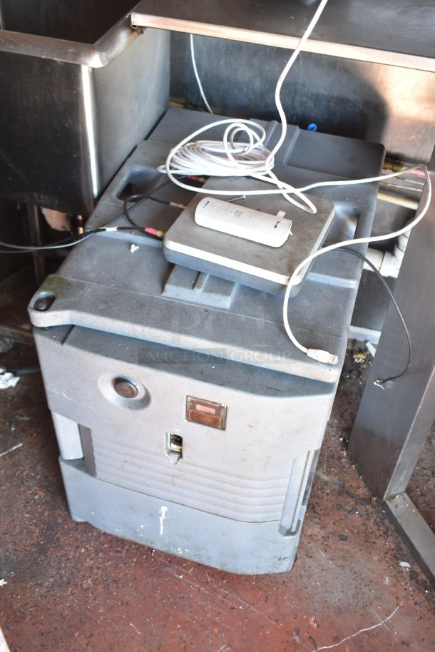2019 mobile kitchen trailer interior with stainless steel sink, cables, and equipment storage container. Dust visible.