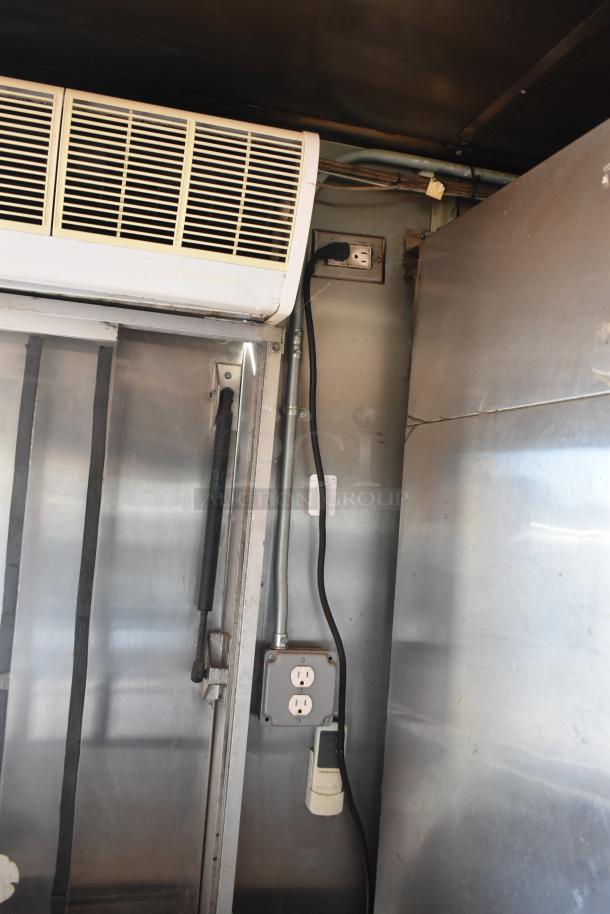 Interior view of a 2019 Quality Cargo mobile kitchen trailer featuring outlets, wiring, and a wall-mounted AC unit.