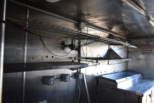 2019 Quality Cargo 8.5' x 24' mobile kitchen trailer, corporate spec, with grease hood, shelves, outlets, and security camera sign.