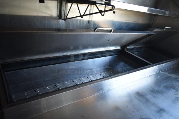 Interior of a 2019 mobile kitchen trailer featuring stainless steel storage compartments and racks, part of a Burger King setup.