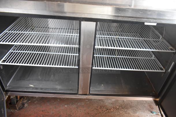 Inside view of refrigerated storage in a 2019 Quality Cargo 8.5' x 24' mobile kitchen trailer, featuring wire shelves.