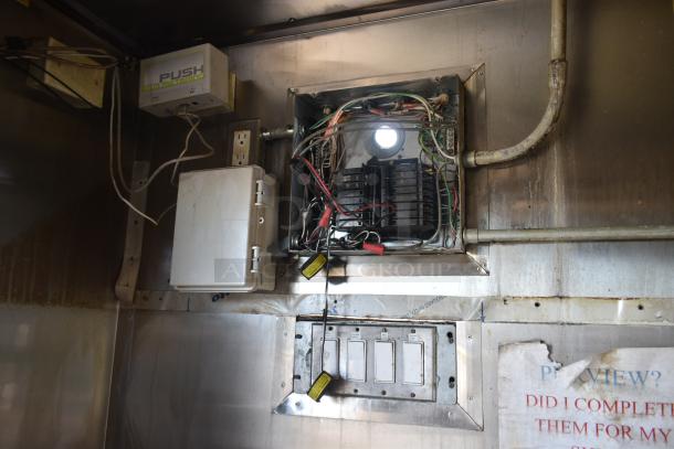 Electrical panel and wiring setup inside a 2019 Quality Cargo mobile kitchen trailer, showcasing internal components and switches.