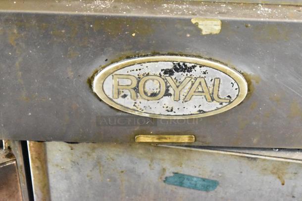 Close-up of a metal label reading "ROYAL" on the 2019 Quality Cargo mobile kitchen trailer.
