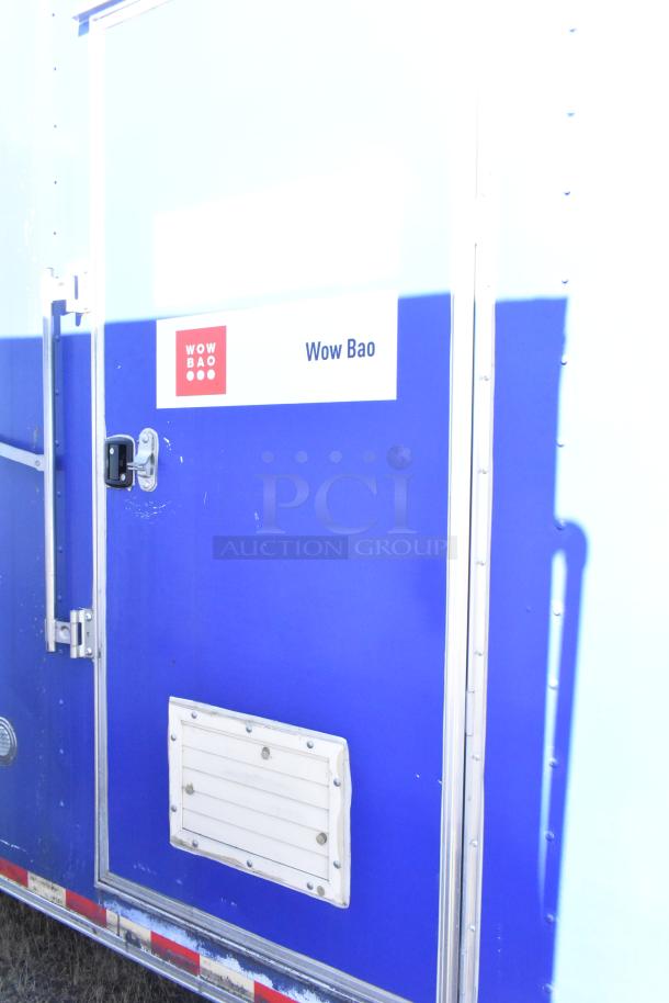 2020 Diamond Cargo 8.5' x 24' mobile kitchen trailer, blue exterior, "Wow Bao" label. Fully equipped with grease hood, refrigeration, fryers, griddle.