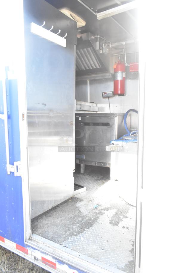 2020 Diamond Cargo 8.5' x 24' mobile kitchen trailer with grease hood, refrigeration, fryers, griddle, and fire extinguisher.