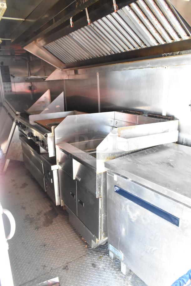 2020 Diamond Cargo 8.5' x 24' mobile kitchen trailer featuring grease hood, refrigeration, fryers, and griddle.