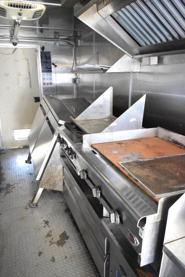 2020 Diamond Cargo 8.5' x 24' mobile kitchen trailer featuring grease hood, refrigeration, fryers, and griddle.