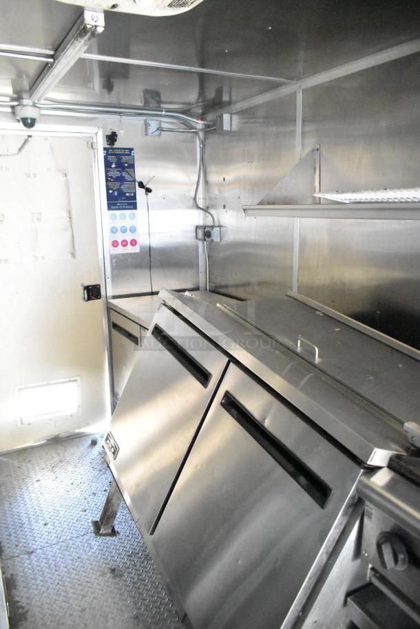 2020 Diamond Cargo 8.5'x24' mobile kitchen interior, featuring stainless steel refrigeration units and prep surfaces.