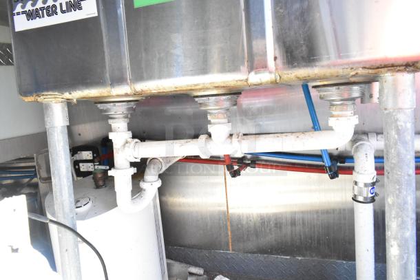 Piping system under sink in 2020 Diamond Cargo mobile kitchen trailer, displaying connections and water lines.