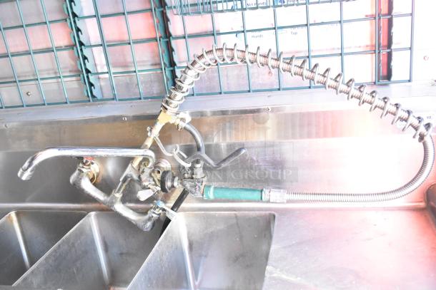 Diamond Cargo 8.5' x 24' mobile kitchen trailer sink with commercial faucet and stainless steel finish.