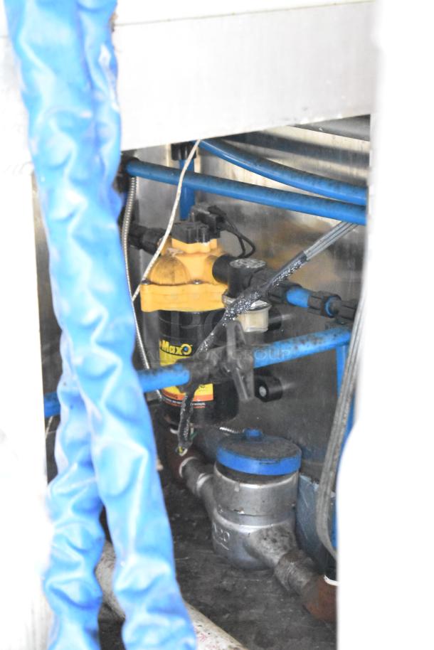 Inside view of Diamond Cargo mobile kitchen trailer plumbing, featuring blue hoses and a yellow Flojet pump.