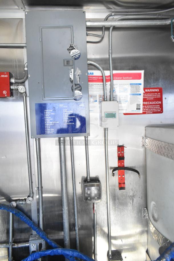 Interior view of the 2020 Diamond Cargo mobile kitchen trailer showing electrical panel, wiring, and safety signage.