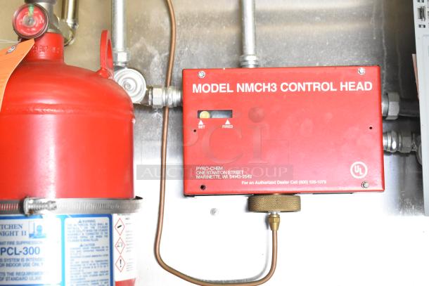 Red Pyro-Chem NMCH3 Control Head and PCL-300 fire suppression unit in a Diamond Cargo 8.5' x 24' mobile kitchen trailer.