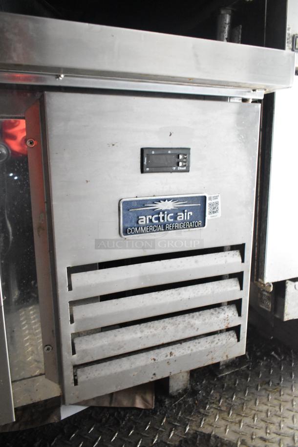 Arctic Air commercial refrigerator in a Diamond Cargo mobile kitchen trailer, showing front vent and logo, used condition.