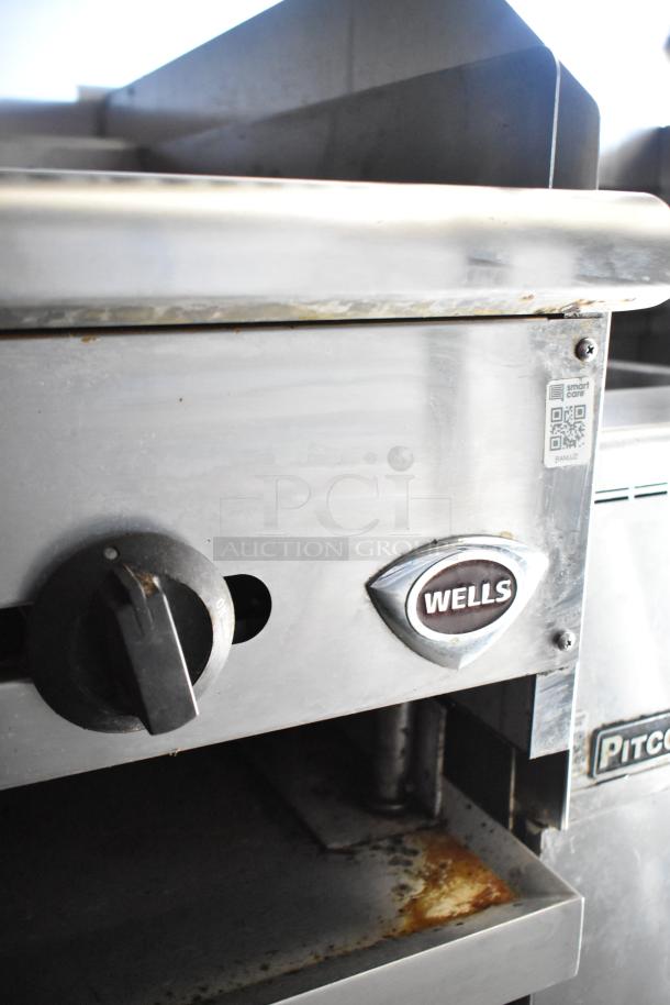 Close-up of Wells cooking equipment in 2020 Diamond Cargo mobile kitchen trailer, showing control dial and brand logo.