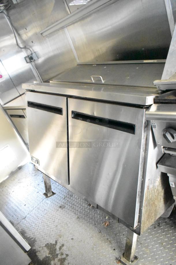 2020 Diamond Cargo mobile kitchen trailer interior, showing stainless steel refrigeration unit with dual doors.