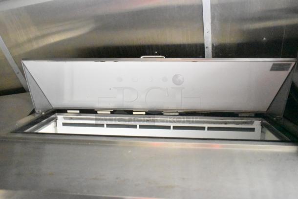 Interior view of a 2020 Diamond Cargo mobile kitchen trailer showing stainless steel surfaces and part of the refrigeration unit.