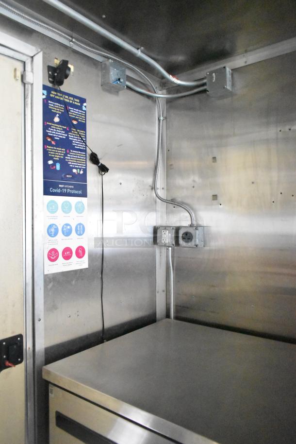 2020 Diamond Cargo 8.5' x 24' mobile kitchen interior showing stainless surfaces, electrical outlets, and COVID-19 protocol signage.