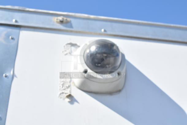 Exterior detail of 2021 Diamond Cargo 8.5' x 24' trailer, showing mounted security camera, white panel, and metal trim.