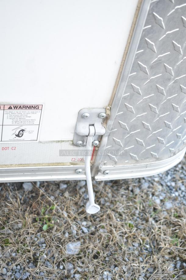 2021 Diamond Cargo trailer handle and safety warning label, on cold food & beverage trailer. VIN 53NBE2429M1089847.