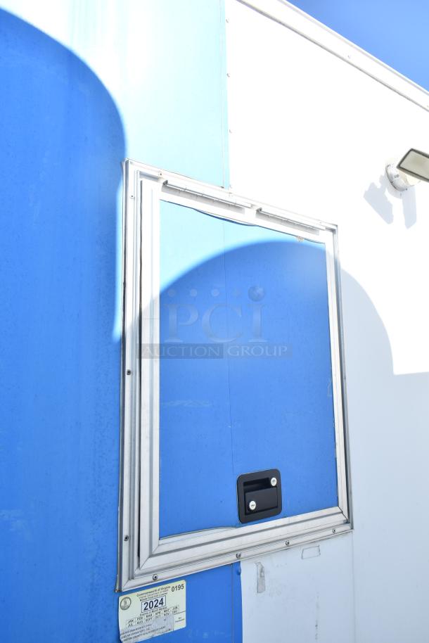 2021 Diamond Cargo 8.5' x 24' trailer, blue and white exterior, side window and latch. Visible VA inspection sticker on lower panel.