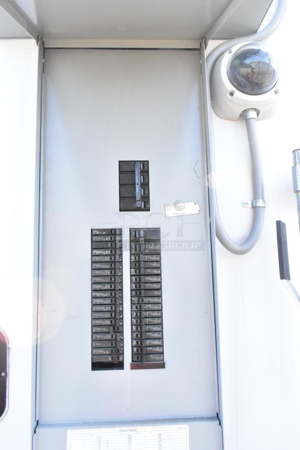 Electrical panel inside 2021 Diamond Cargo 8.5' x 24' food trailer with grease hood and AC system. VIN 53NBE2424M1089724.