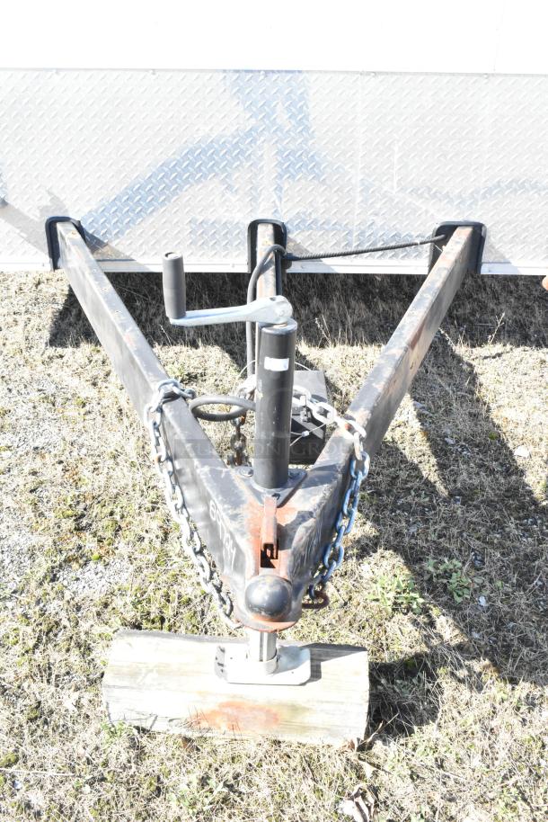 2021 Diamond Cargo food trailer hitch, chain, and handle on grass. Trailer includes grease hood and AC system.