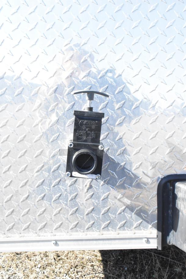 2021 Diamond Cargo food trailer exterior with a visible 1.5" blade valve. Diamond plate finish, includes grease hood and A/C.