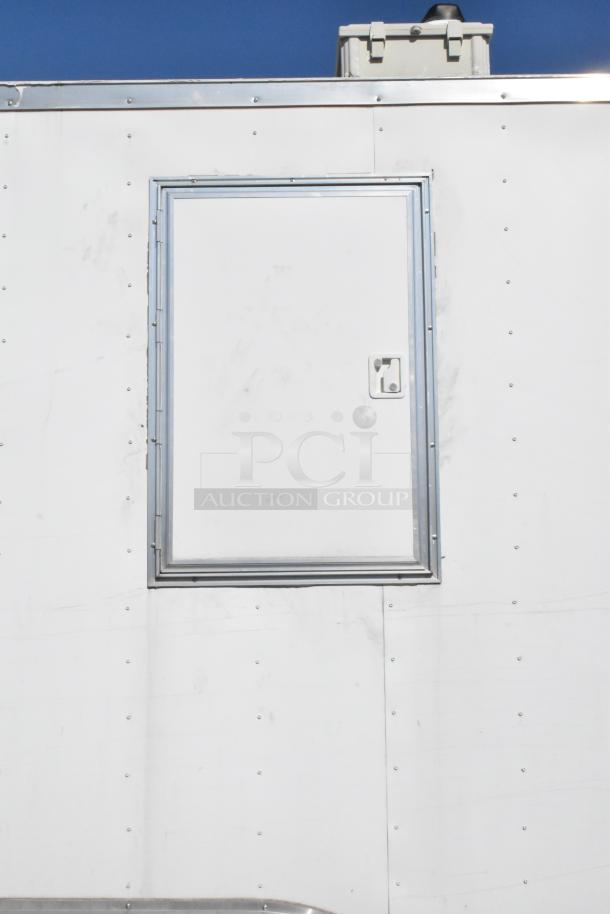 2021 Diamond Cargo 8.5' x 24' food trailer, white exterior, includes grease hood and AC, showing side panel detail.