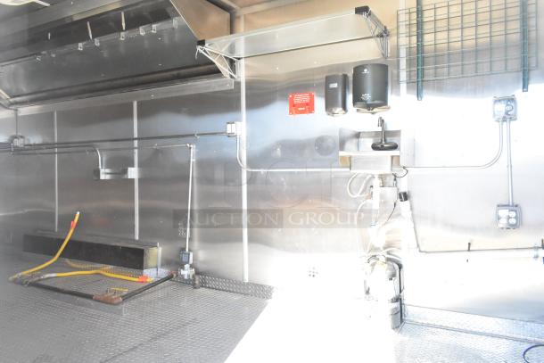 2021 Diamond Cargo 8.5' x 24' food trailer interior with stainless steel walls, grease hood, sink, and air conditioning system.
