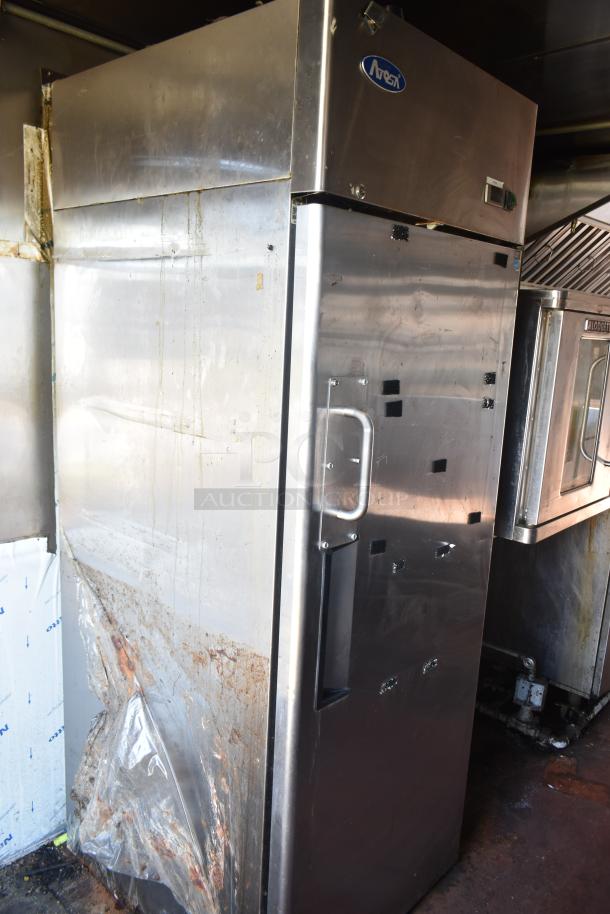 2012 Quality Cargo food trailer interior with a commercial stainless steel refrigerator. Signs of wear visible on surfaces.
