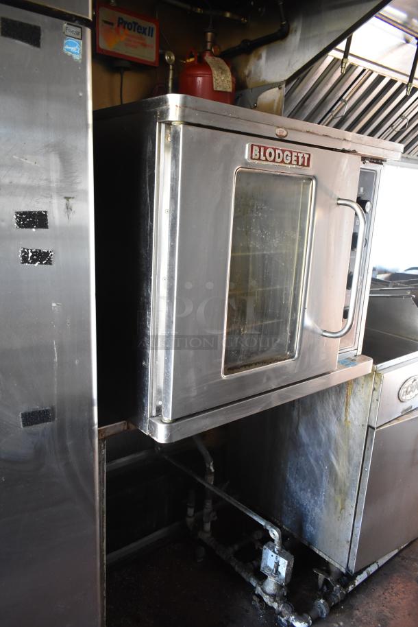 2012 Quality Cargo food trailer features a Blodgett oven, dual fryer, and pizza prep setup. Condition shows signs of use.