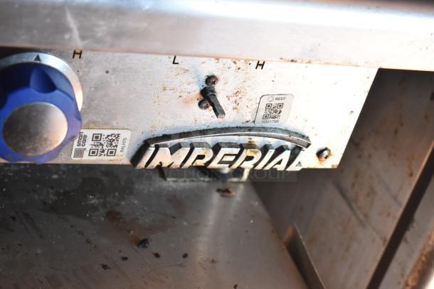 2012 Quality Cargo food trailer interior with Imperial label, showing cooking equipment knobs and QR code tag.