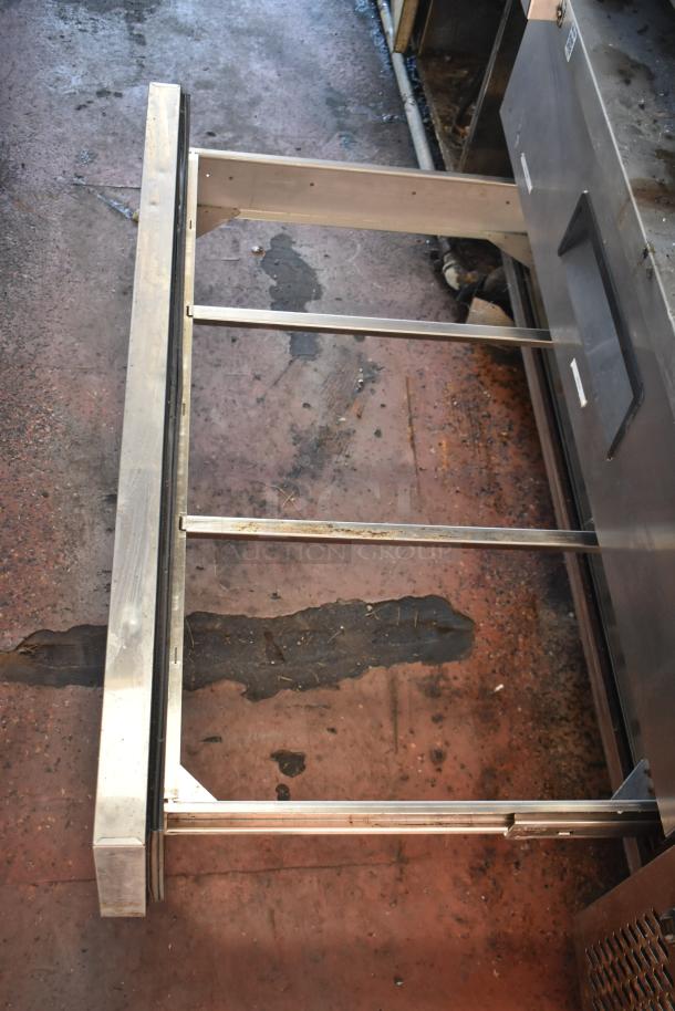 2012 Quality Cargo food trailer interior showing metal framing for dual fryer and pizza prep setup, slightly worn condition.