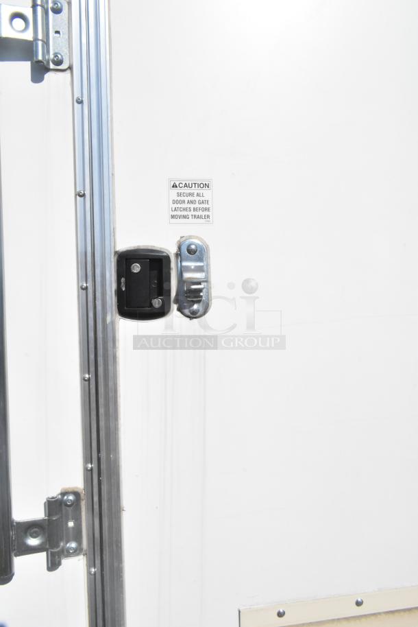 2021 Diamond Cargo 8.5' x 24' food trailer door with latch and warning label. Includes grease hood, AC system. VIN: 53NBE2424M1089724.