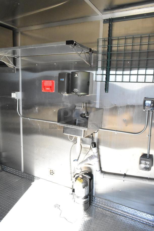 2021 Diamond Cargo 8.5' x 24' food trailer interior with sink, grease hood, air conditioning, and wiring visible.