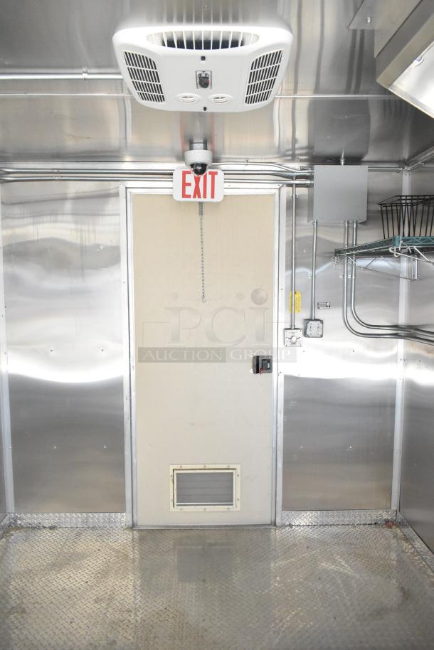 2021 Diamond Cargo 8.5' x 24' food trailer interior with air conditioning, grease hood, and exit sign. Clean condition.