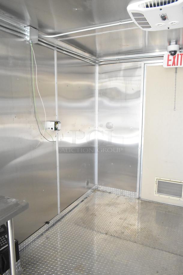 2021 Diamond Cargo 8.5' x 24' food trailer interior with stainless steel walls and diamond plate flooring. Includes air conditioning and grease hood.