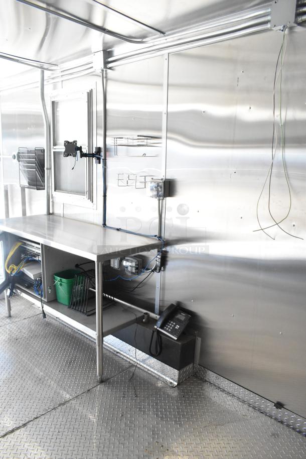 2021 Diamond Cargo 8.5' x 24' food trailer interior, featuring stainless surfaces, wiring, and shelving. Includes grease hood, AC.