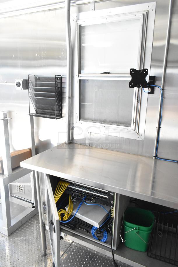 2021 Diamond Cargo 8.5' x 24' food trailer interior with stainless steel surfaces, wiring setup, and window.