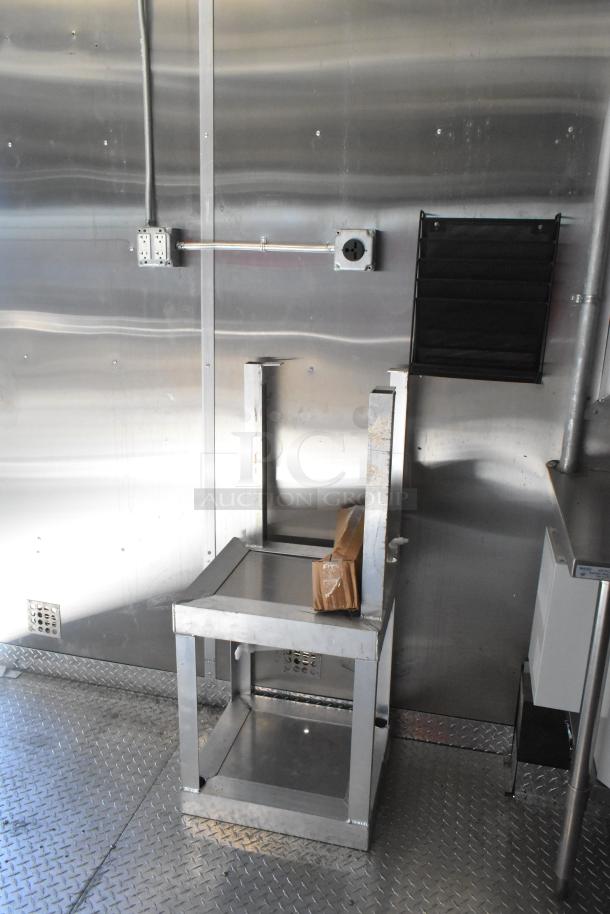 2021 Diamond Cargo 8.5' x 24' food trailer interior, featuring stainless steel walls, grease hood, and electrical outlets.