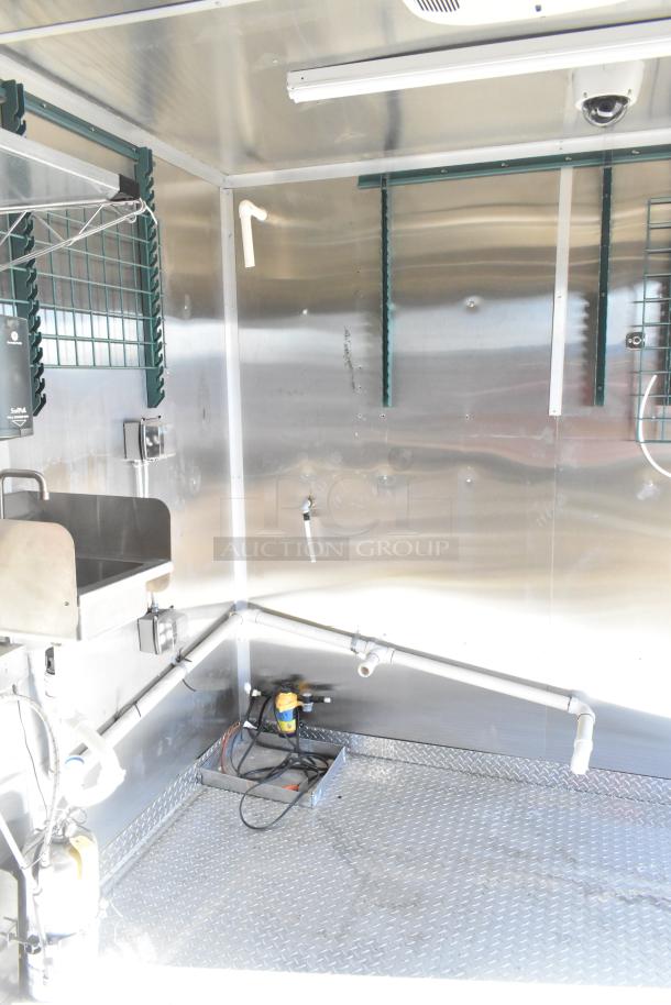 2021 Diamond Cargo 8.5' x 24' food trailer interior, featuring grease hood, sink, and air conditioning system.