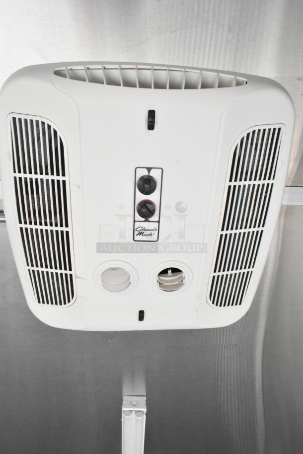 Ceiling-mounted Coleman-Mach air conditioning unit in a 2021 Diamond Cargo food trailer, featuring control knobs.